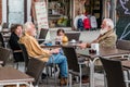 Street life in Venice. People relaxing in a street cafe