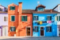 Typical colorful house of Burano Island with hanging laundry at its facade Royalty Free Stock Photo