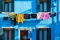 Typical colorful house of Burano Island with hanging laundry at its facade Royalty Free Stock Photo