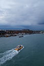 Venice, Italy - October, 6 2019: Vaporetti or Venetian public water buses, or water taxies in Venetian Lagoon at Cruise