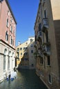 Venice, Italy, October 2021: View of a narrow canal surrounded by old brick houses in Venice. Royalty Free Stock Photo