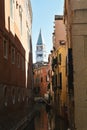 Venice, Italy, October 2021: View of a narrow canal surrounded by old brick houses. Royalty Free Stock Photo