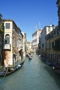 Venice, Italy, October 2021: View of a narrow canal surrounded by old brick houses in Venice. Royalty Free Stock Photo