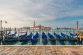 Venice, Italy. Pier with moored gondolas on Saint Mark square with San Giorgio di Maggiore church on background Royalty Free Stock Photo