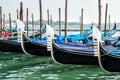 Venice, Italy. Retro transport, details. Pier with old black wooden gondolas. The embankment of the Grand Canal. Royalty Free Stock Photo