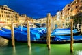 Venice, Italy. Rialto bridge and Grand Canal at twilight blue hour. Gondolas on the foreground. Tourism and travel concept Royalty Free Stock Photo