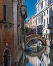 typical boat and bridge along a canal in Venice Royalty Free Stock Photo