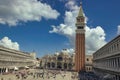 Venice, Italy: Saint Mark square, basilica, bell tower and square with crowd of people and tourists, blue sky Royalty Free Stock Photo