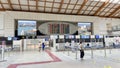 VENICE,ITALY.16 SEPTEMBER 2023.In Venice Airport, a small group lingers by the flight info board near quiet check-in counters Royalty Free Stock Photo