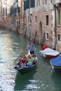 City tour by tourists with gondola, narrow channel , Venice, Italy