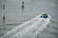 Venice. Italy - September 29, 2025: A worker on the deck of a harbor service boat Royalty Free Stock Photo