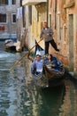 A pair of Asian tourists on a romantic trip in the gondola. Venice, Italy