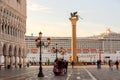 Venice, Italy - September, 2017: Palazzo Ducale Doge palace, Winged lion column at San Marco Square with big cruise ship in the Royalty Free Stock Photo