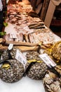 Venice, Italy - September, 2016: Rialto Fish Market. Fresh seafood is displayed on crushed ice under fluorescent lights. Shellfis