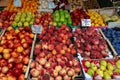 Venice, Italy - september 2016: Rialto fish markets. Fishmonger at work.Tablets with price of peaches and apples. Royalty Free Stock Photo