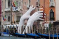 Support Sculpture by Lorenzo Quinn putting two giant hands protruding from the Grand Canal water, Venice, Italy