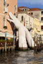 Support Sculpture by Lorenzo Quinn putting two giant hands protruding from the Grand Canal water, Venice, Italy