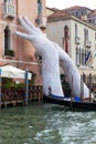 Support Sculpture by Lorenzo Quinn putting two giant hands protruding from the Grand Canal water, Venice, Italy