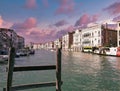 Venice, Italy - September 02, 2018: A wooden fence against Italian architecture on Grand canal against dramatic sky Royalty Free Stock Photo