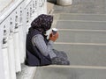 Poverty and begging, woman on stairs Royalty Free Stock Photo