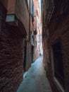 Venice, Italy - 17.10.2023: Small narrow street and people walking in background. City mood