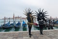 Carnival masked people near San Marco`s Square