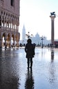 Venice Italy St Mark Square with high tide and a tourist near th