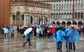 Tourists on a rainy day in Piazza San Marco St Marks Square.