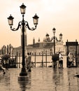 Tourists on a rainy day in Piazza San Marco St Marks Square.