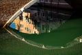 Venice, Italy. Traditional canal bridge reflection on green water. Royalty Free Stock Photo