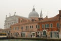 Venice, italy: traditional venice scene. church dome water taxi mist