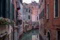 Typical canal scene in Venice with reflection in the water. Royalty Free Stock Photo