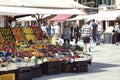 Venice, Italy, 05.26.2022: view on city street with pedestrians and fruits and vegetable market stand on the square Royalty Free Stock Photo