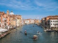 Venice, Italy - 17.10.2023: View on different boats moving in Grand Canal, busy unique city life. Warm sunny day with blue cloudy Royalty Free Stock Photo