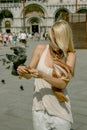 `Venice`, Italy young girl woman feed dove