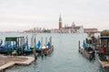 Venice lagoon, San Giorgio church, gondolas and poles, Italy