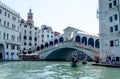 Venice and a large bridge crossing a water canal with people