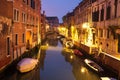 Venice night cityscape with boats in canal, Italy. Venice street illuminated lanterns Royalty Free Stock Photo