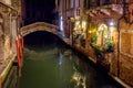 Venice at night, Italy. Beautiful narrow canal with bridge and vintage houses Royalty Free Stock Photo