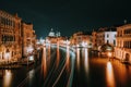 Venice night scenery. Light illuminated trails of ferries and boats reflected on the Grand Canal surface. Majestic Royalty Free Stock Photo