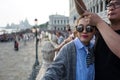 Venice - October 04: Unknown Asian tourists make a selfie in front of the famous Ponte dei Sospiri bridge on October 04