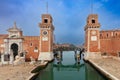 Venice. Old stone towers of the arsenal over the canal on a sunny day.