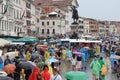 Venice on a rainy day, full of tourists wearing colorful raincoats and umbrellas