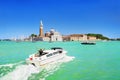 Venice seascape. Giudecca Canal and San Giorgio Maggiore island, Italy, Europe. Motor boat with Italian flag and woman up her Royalty Free Stock Photo