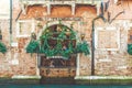 Venice September 4 2018: Beautiful view of the cafe windows, with tourists sitting in it, decorated with vertically growing plants