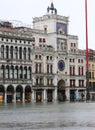 Venice submerged by high tide and water in Saint Mark Square wit Royalty Free Stock Photo