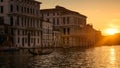 Venice at sunset, Italy. Gondola with tourists sails on Grand Canal at night