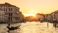 Venice at sunset, Italy. Gondola with tourists sails on Grand Canal at night Royalty Free Stock Photo