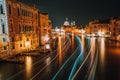 Venice twilight blue night scenery. Light illuminated trails of ferries and boats reflected on the Grand Canal surface Royalty Free Stock Photo