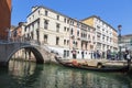 Venice. Urban landscape with canal, bridge, gondola, tourists